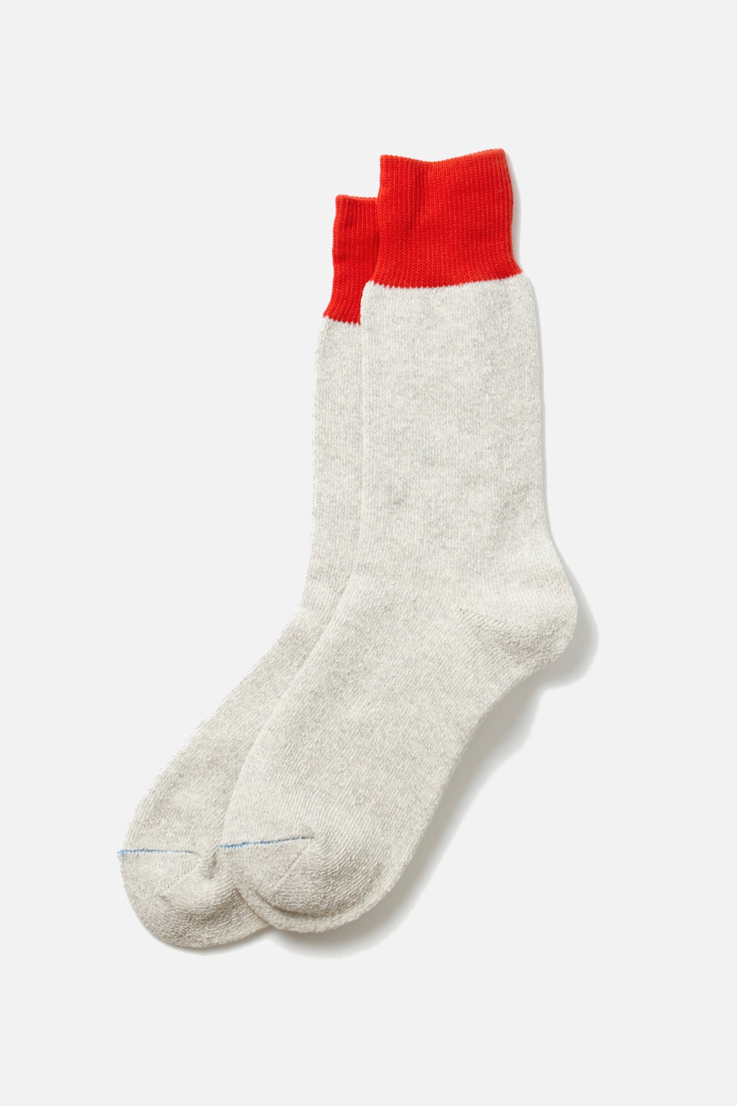 A pair of RoToTo Double Face Silk Cotton Crew Socks in Red Light Grey, from RoToTo, laid flat on a white background.