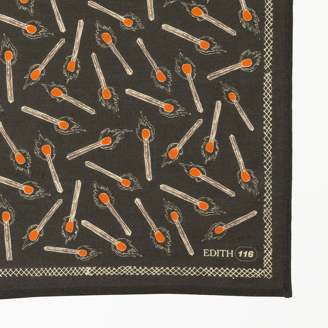 The Handker Bandanas No. 116 Edith Bandana by Handker Bandanas is a premium charcoal gray cotton bandana with burning match illustrations, a geometric border, and "EDITH 116" in light text on the lower right corner.