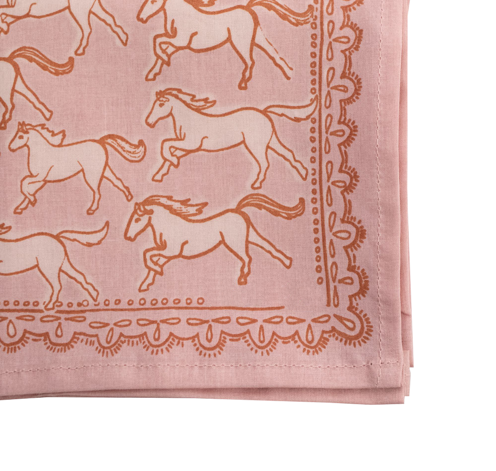 The Handker Bandanas - No. 062 Horses Bandana by Handker Bandanas is a premium cotton, light pink bandana with an orange border, featuring a repeating horse print and decorative edge accents.