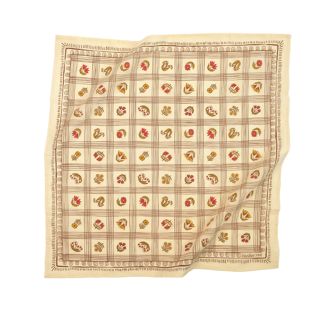 The Handker Bandanas - No. 130 Laura Bandana is a square beige premium cotton accessory with a grid of small red, yellow, and brown floral and leaf motifs, hand screen-printed by Handker Bandanas and showcasing both sides beautifully.