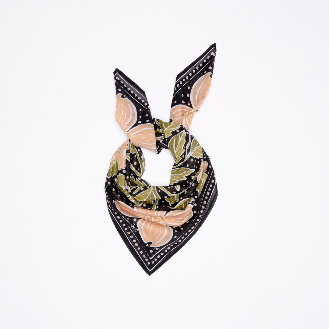 The Handker Bandanas - 34" Wild Rag Amy Bandana from Handker Bandanas, featuring black, beige, and green floral patterns, is folded and tied in a knot against a white background.