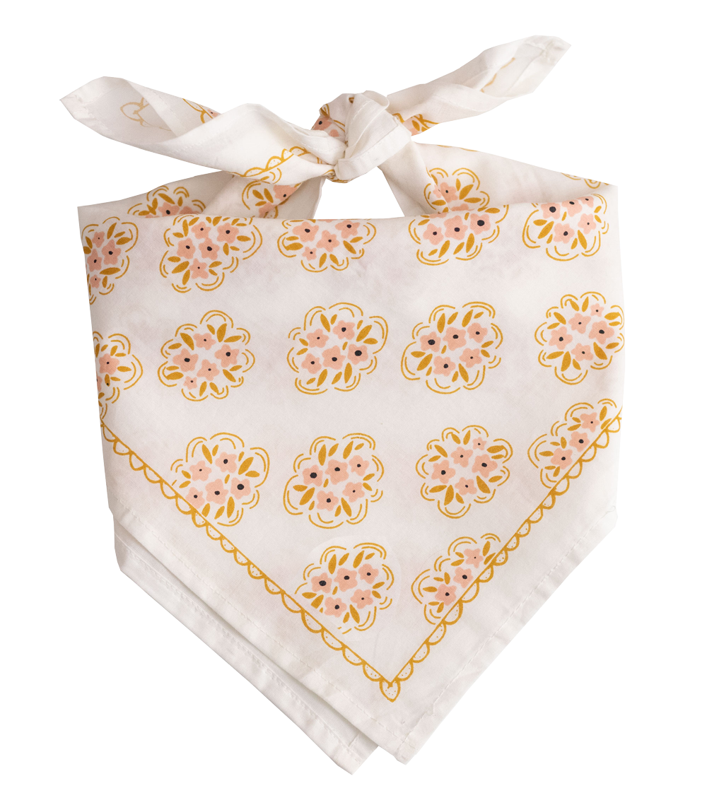 The Handker Bandanas - No. 042 Pearl Bandana by Handker Bandanas is a white cotton bandana with pink and yellow floral patterns and a decorative border, perfect for adding color to your look.