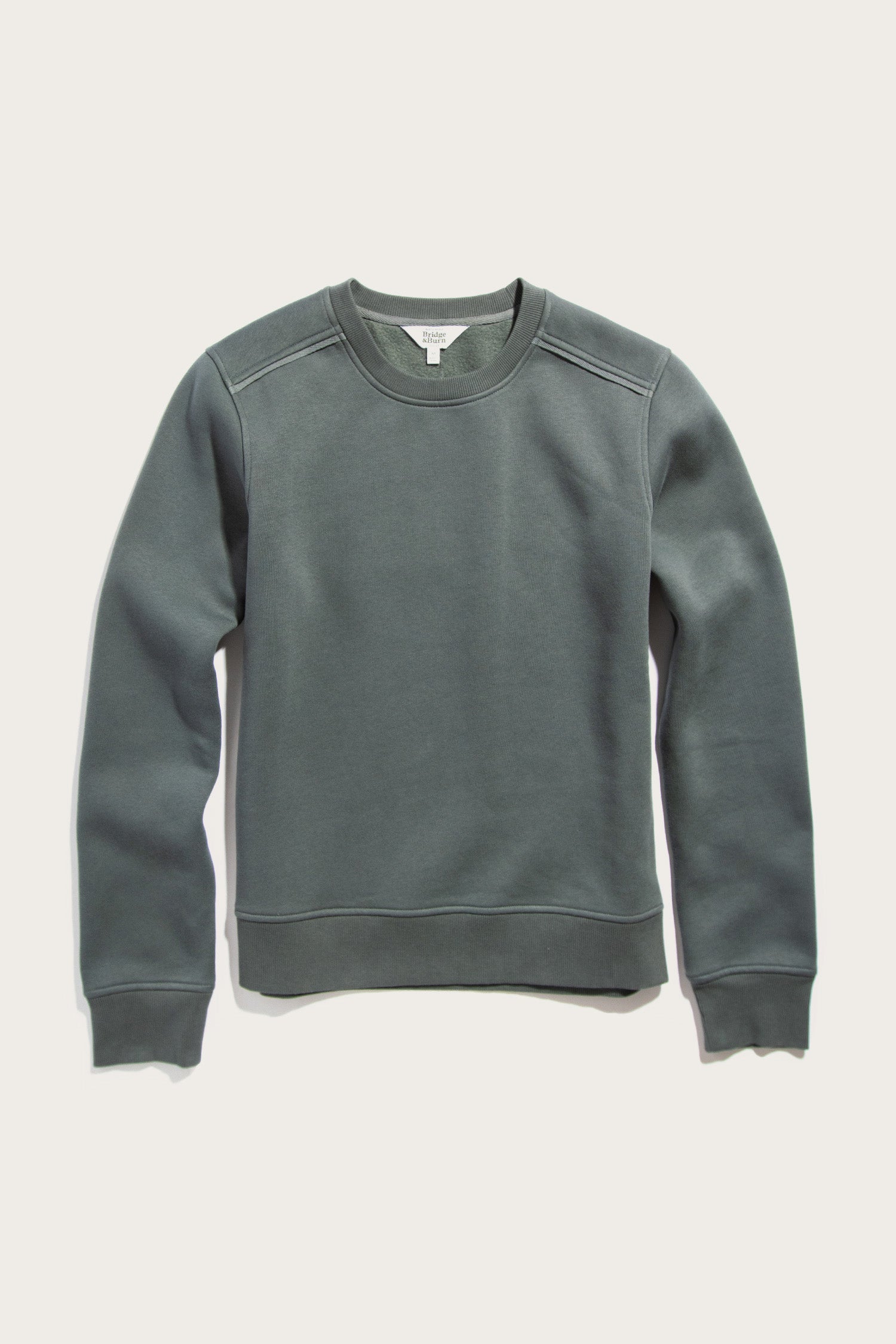 The Bailey Crew Sweatshirt by Bridge & Burn in Slate is a long-sleeve, crew neck top made from organic cotton, shown laid flat on a light background.