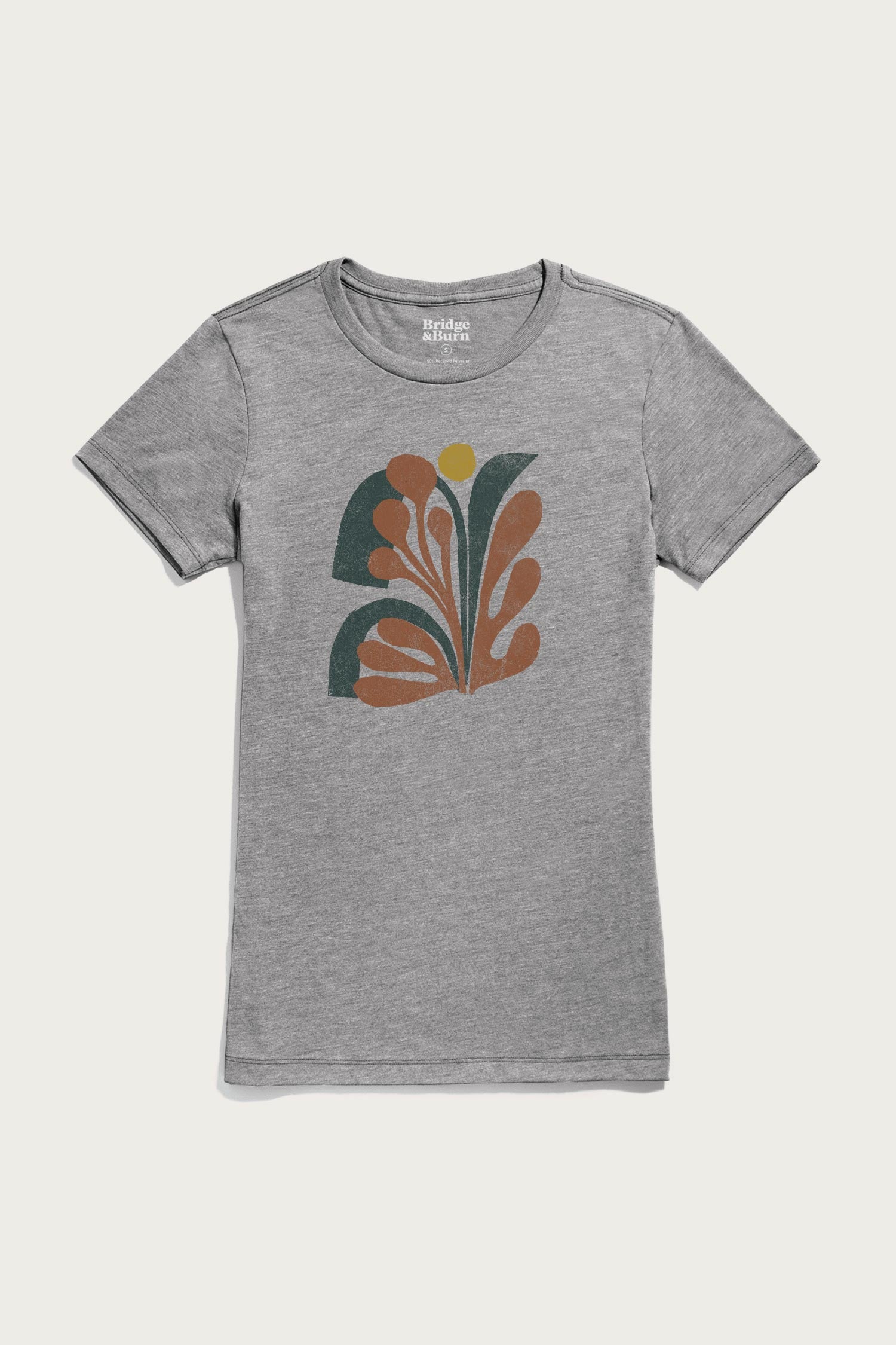 The Bridge & Burn Women's Bloom Tee in grey is a lightweight shirt with an abstract, retro-inspired chest design featuring curved orange, green, and yellow shapes.