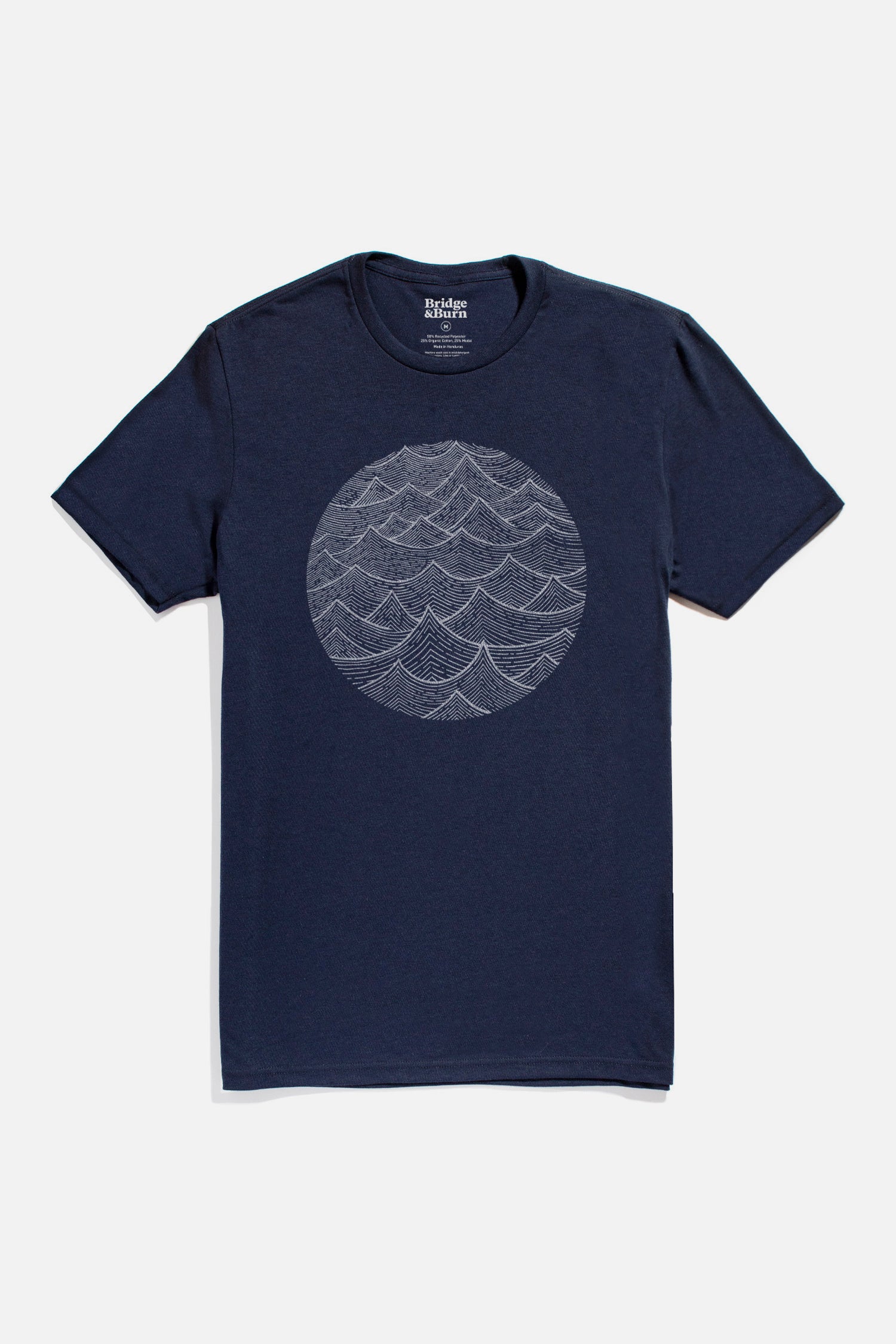 Bridge & Burn Men's Waves Tee in navy—organic cotton, short sleeves, with a circular white overlapping waves line art on the chest, shown against a plain white background.