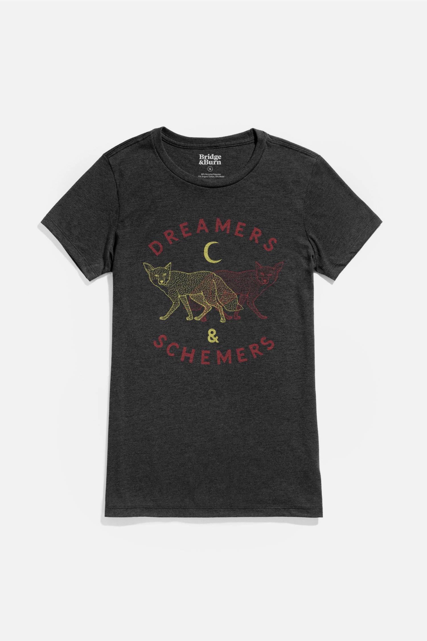 The Bridge & Burn Women's Dreamers & Schemers Tee in black is an organic cotton shirt featuring a fox and crescent moon illustration with "DREAMERS & SCHEMERS" text encircling the design.