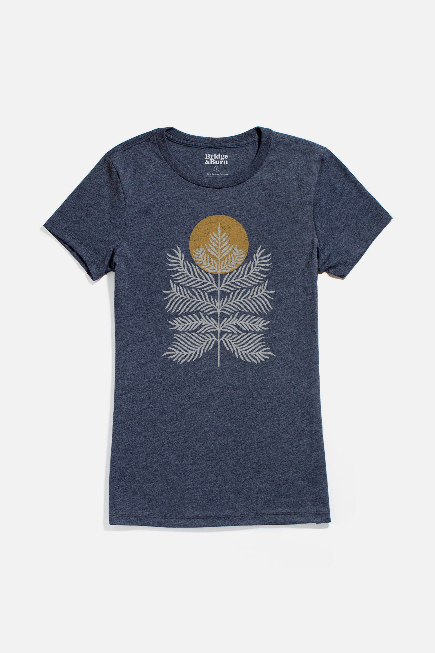 The Bridge & Burn Women's Peace In Plants Tee in navy is a lightweight, heathered t-shirt with white fern leaves and a gold sun graphic, shown flat on a white background.