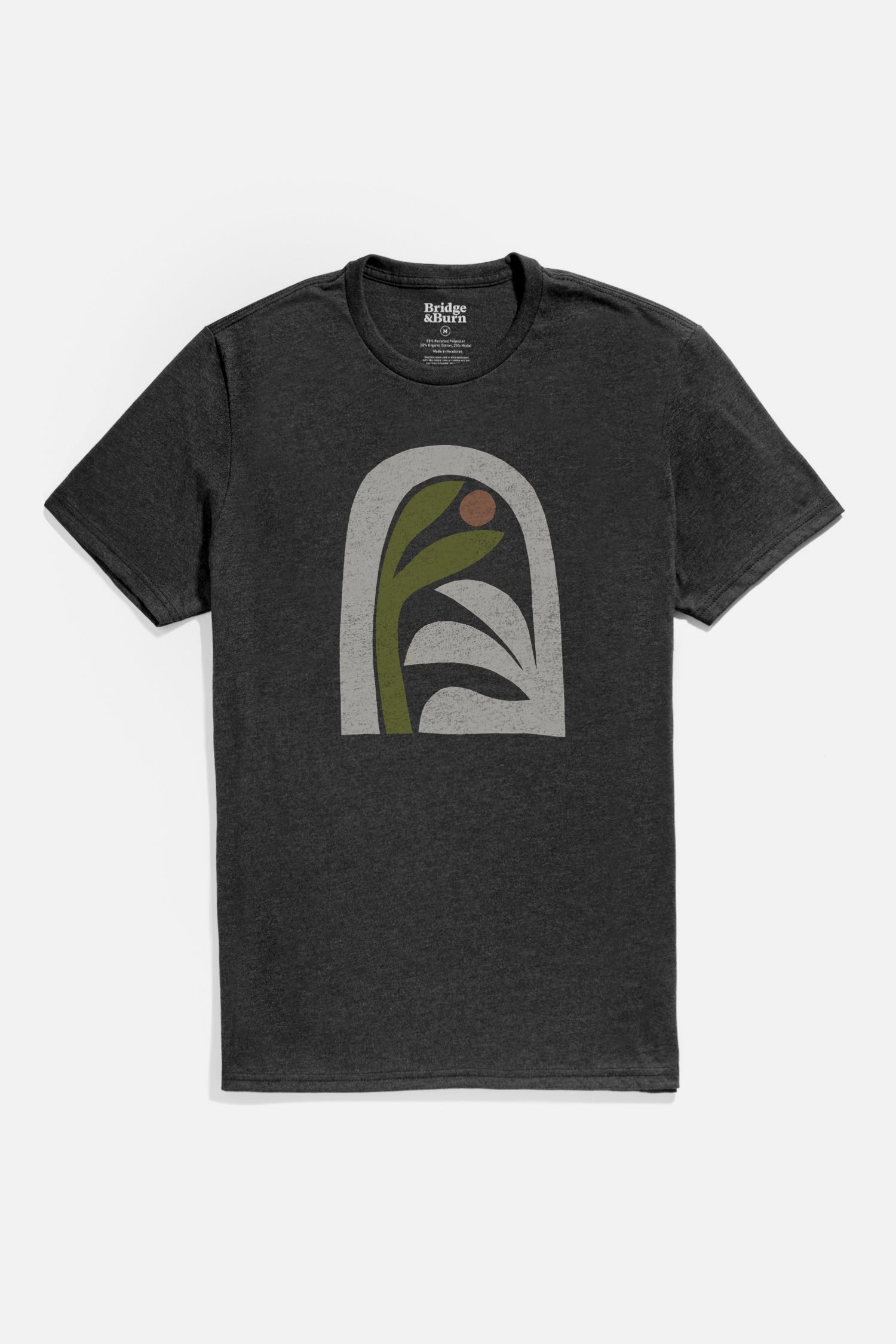 The Bridge & Burn Men's Arch Tee in Charcoal is a lightweight t-shirt featuring a minimalist abstract chest graphic with a green stem, brown circle, and white leaf shapes within a light gray arch.