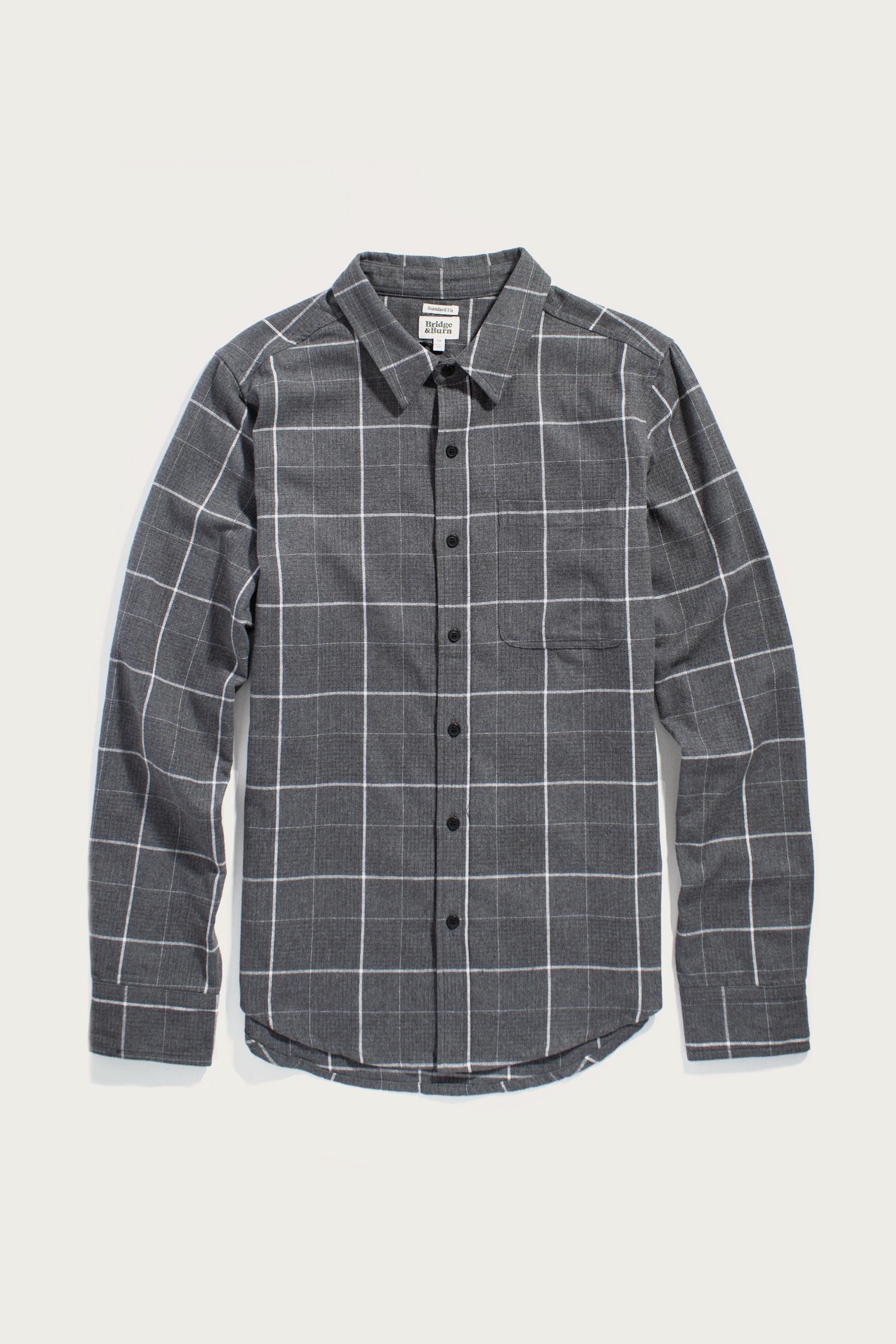 The Bridge & Burn Larson Shirt in Shadow Twill Windowpane is a classic fit, long-sleeve button-up with a black and white grid pattern, soft brushed flannel, collar, and chest pocket—shown on a plain white background.
