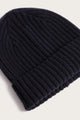 A close-up of the Bridge & Burn Chunky Ribbed Beanie in Dark Navy, featuring a folded brim and soft knit texture, displayed against a light background.