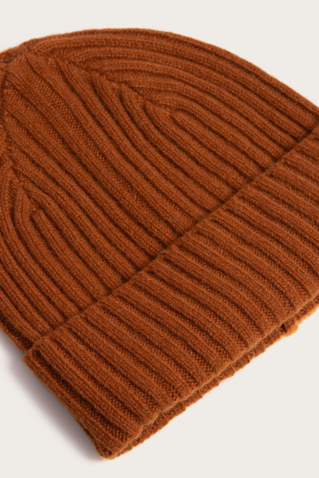 The Bridge & Burn Chunky Ribbed Beanie in Sienna features a folded brim and soft merino wool, shown close-up against a white background.