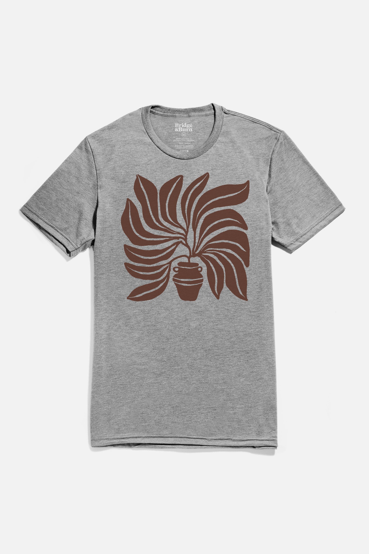 The Men's Grown Tee in grey by Bridge & Burn is a lightweight short-sleeve shirt featuring a large stylized brown potted plant graphic with curved leaves on the front.