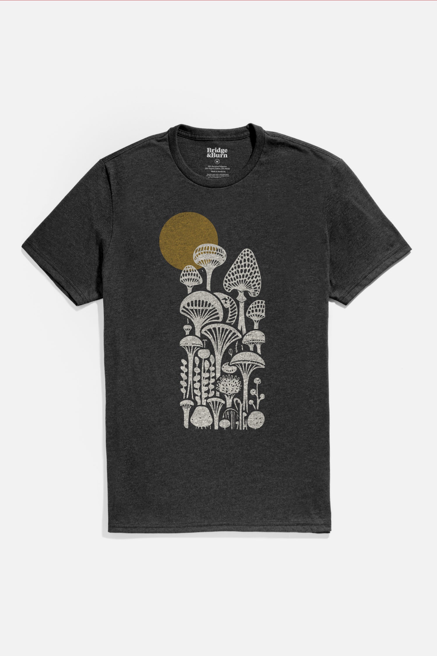 Bridge & Burn's Men's Mycology Tee in black features detailed white mushrooms and plants with a gold sun or moon silhouette, crafted from soft organic cotton for comfort and sustainability.