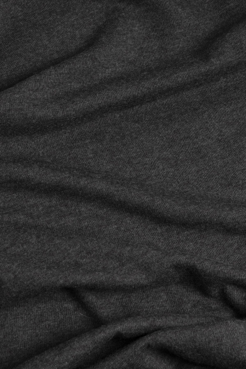 A close-up of the Men's Mycology Tee in Black by Bridge & Burn, featuring dark gray, textured fabric made from recycled plastic bottles, with soft folds and subtle creases across the surface.