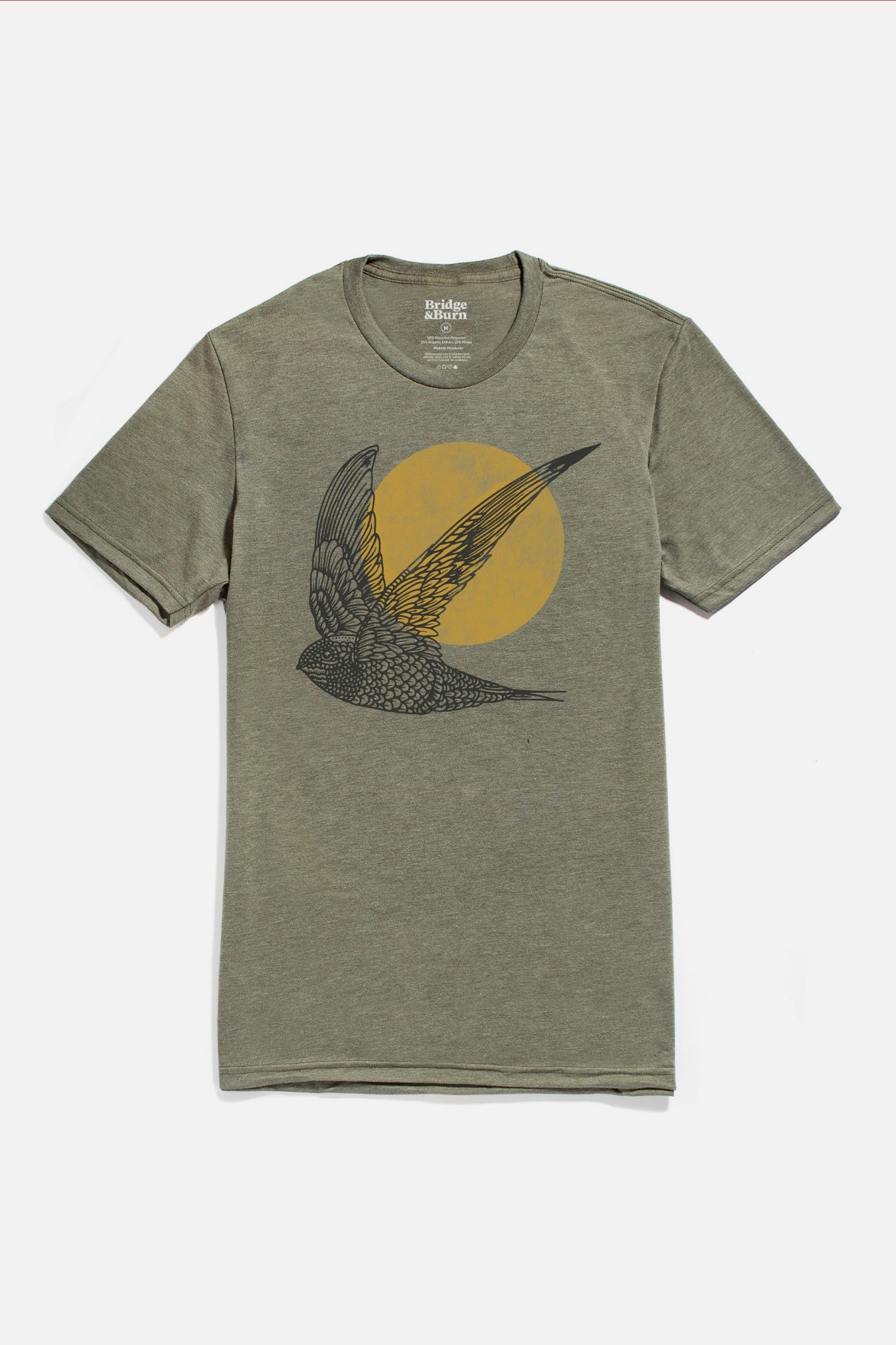 The Bridge & Burn Men's Flown Tee in olive features a black bird in flight before a bold yellow circle, centered on the chest for a modern, lightweight look.