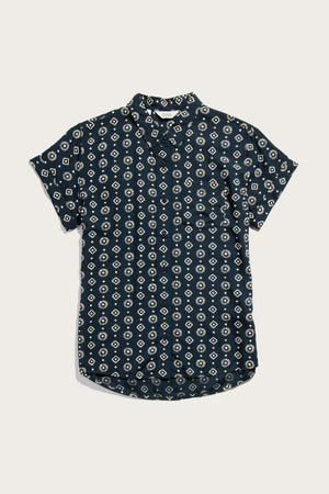 The Bridge & Burn Bea Shirt in Midnight Sundance is a tailored fit, short-sleeve button-down featuring a dark navy base with a white geometric diamond pattern, shown flat on a white surface for stylish and comfortable appeal.