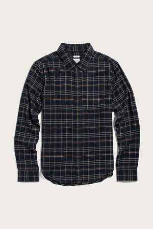 Bridge & Burn's Sutton Slim Shirt in Dusk Herringbone Plaid is a slim-fit, long-sleeve button-up with a navy and beige plaid pattern, classic collar, and single chest pocket, shown laid flat on a light background.
