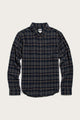Bridge & Burn's Sutton Slim Shirt in Dusk Herringbone Plaid is a slim-fit, long-sleeve button-up with a navy and beige plaid pattern, classic collar, and single chest pocket, shown laid flat on a light background.
