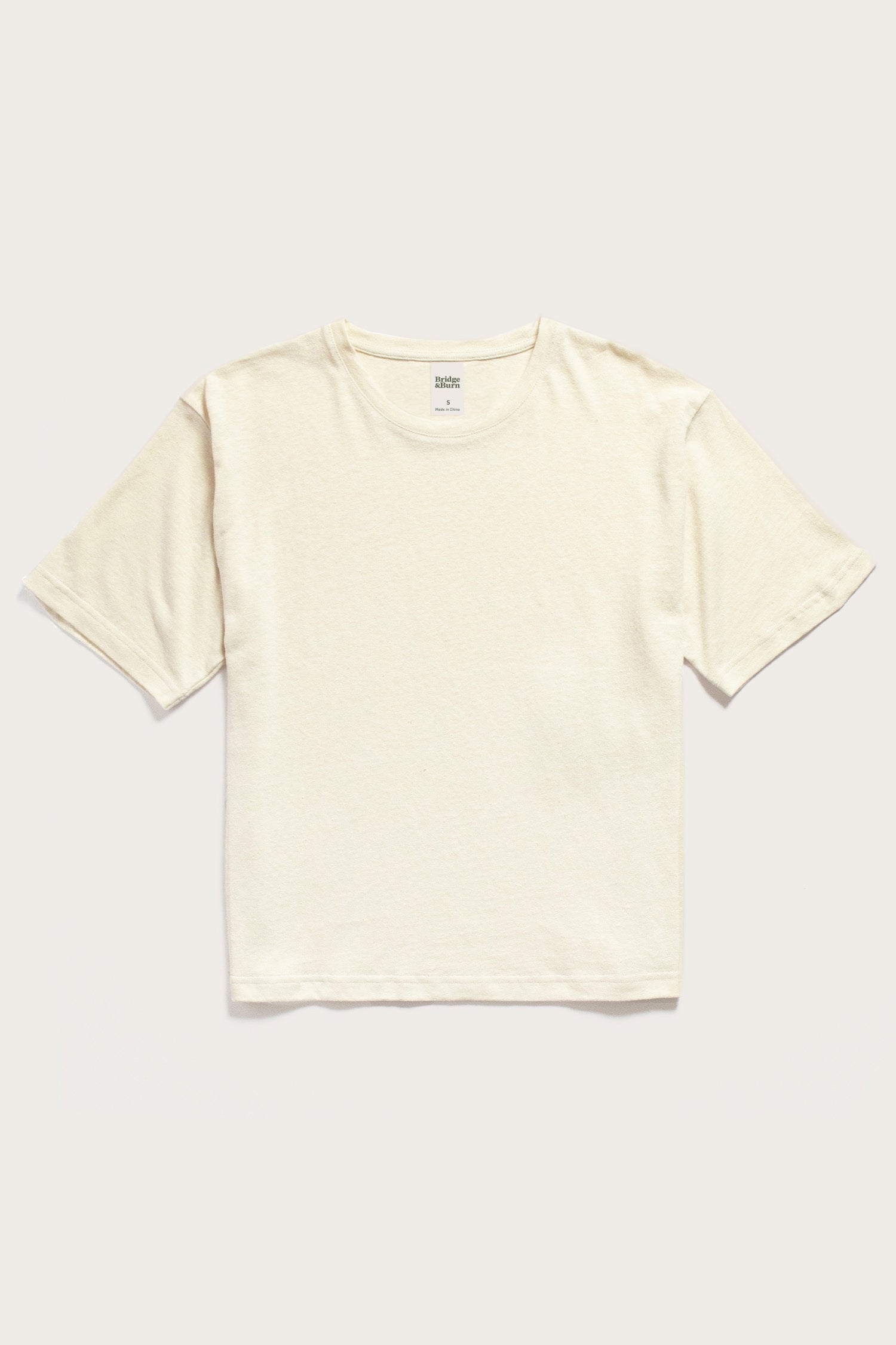 The Bridge & Burn Organic Hemp Boxy Tee in Ivory is a short-sleeved, crew neck top made from organic cotton and hemp, shown against a light background.