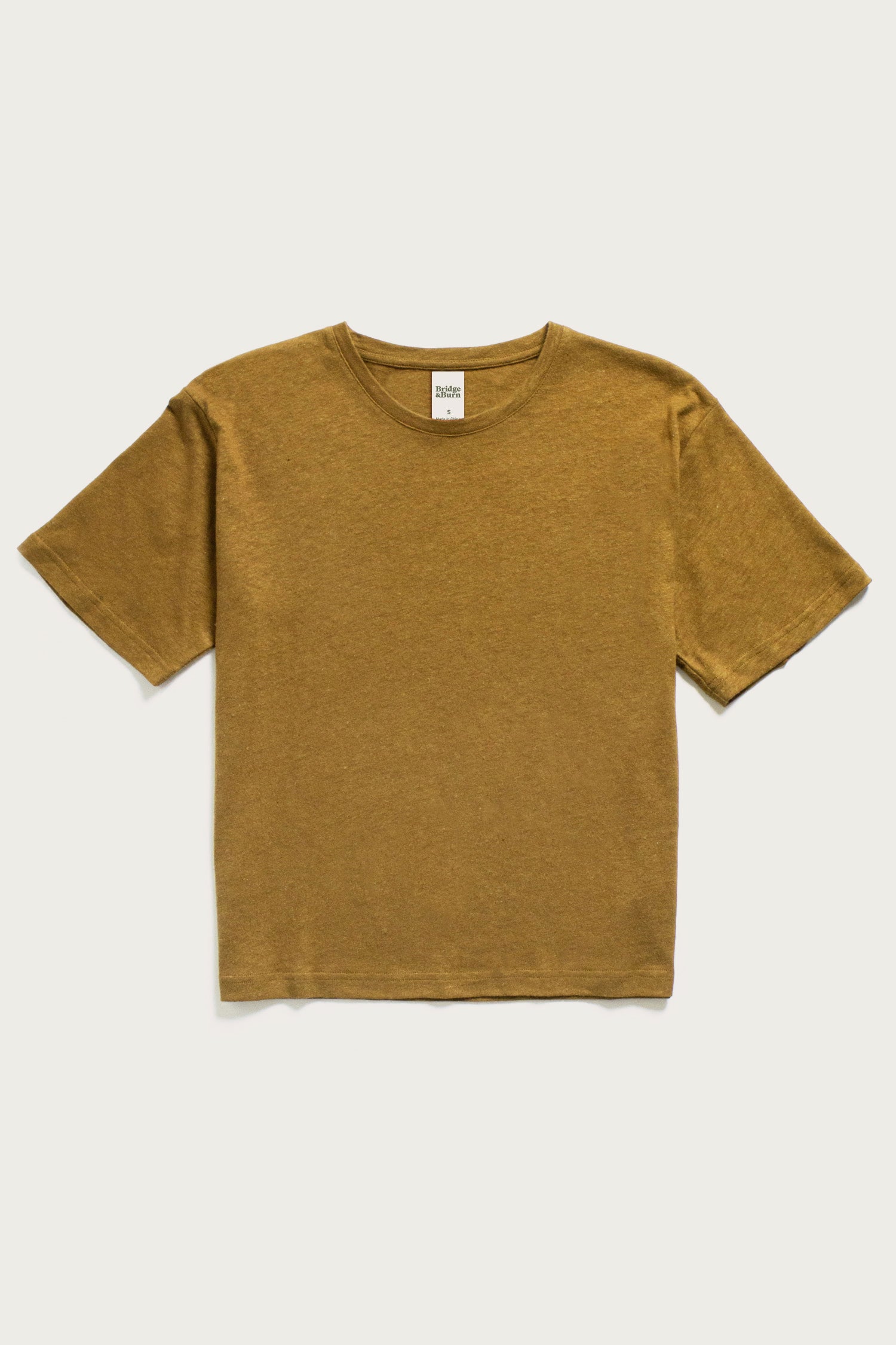 The Bridge & Burn Organic Hemp Boxy Tee in Ochre is displayed on a white background. This vintage-inspired shirt features short sleeves, a crew neckline, and a simple, relaxed fit.