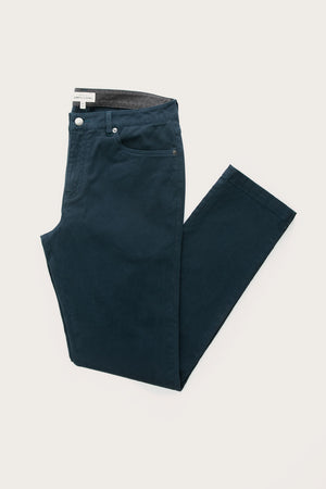 The Bridge & Burn Polk Pant in navy—a pair of straight-fit pants with front pockets and a visible waistband lining—neatly folded and displayed on a plain white background.