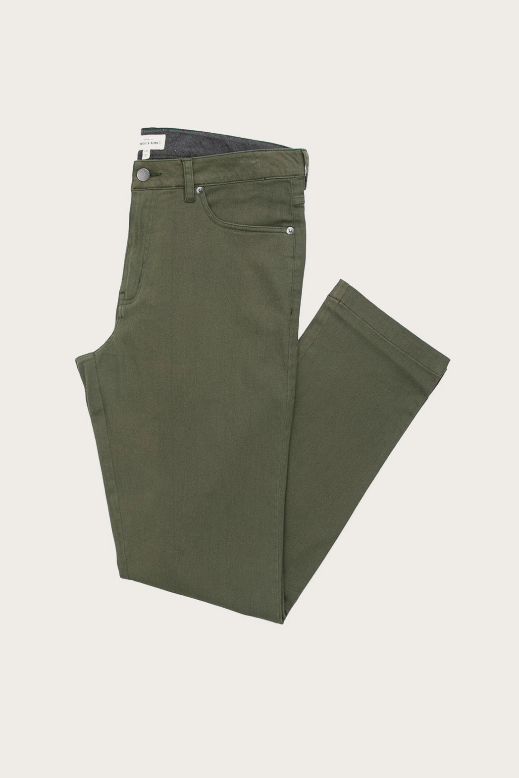 The Bridge & Burn Polk Pant in olive, a straight-fit style with classic 5-pocket design, is shown folded neatly with waistband and button visible against a plain light background.