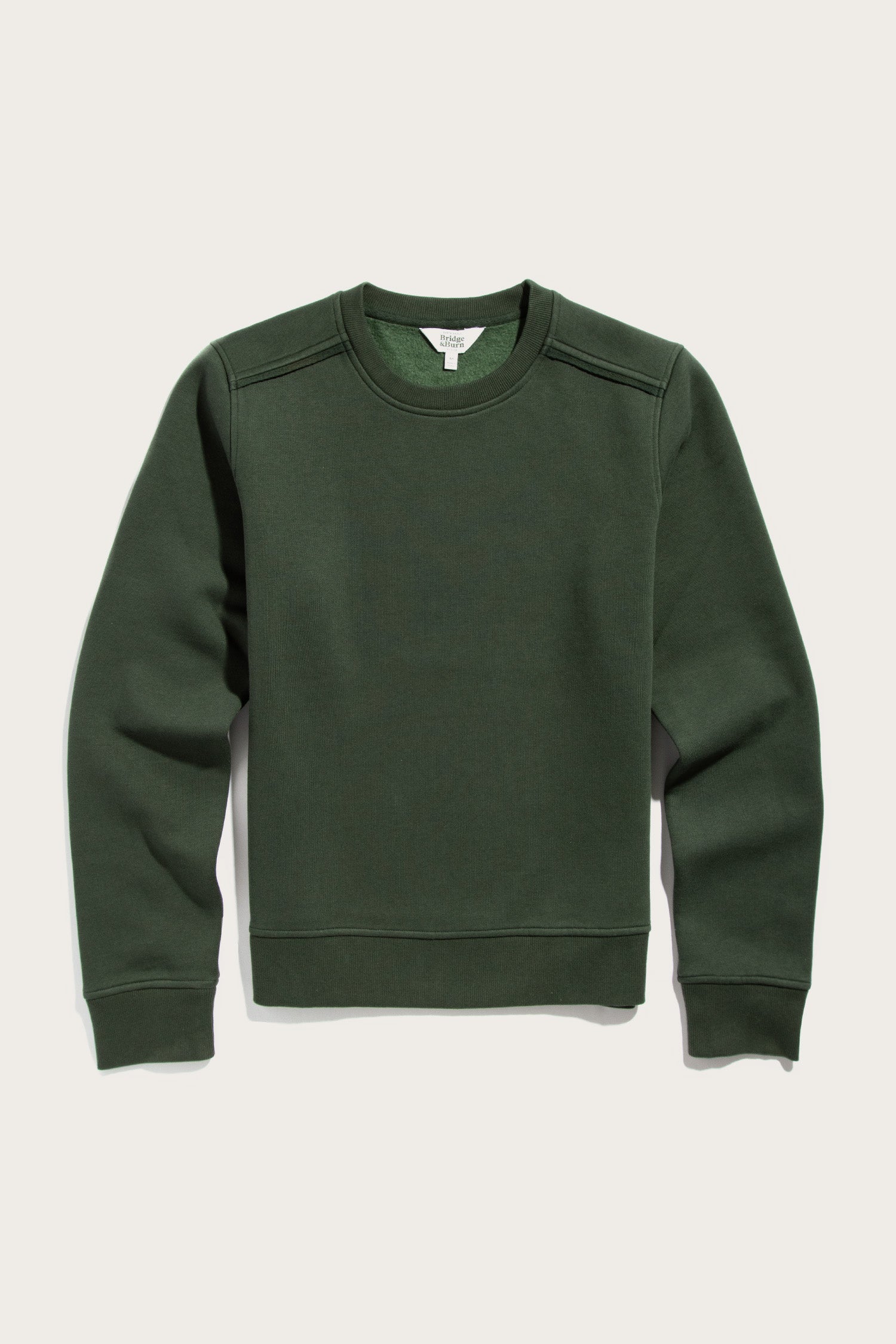 The Bridge & Burn Bailey Crew Sweatshirt in Forest Night is a relaxed fit, sustainable sweatshirt featuring long sleeves, ribbed cuffs and hem—shown against a light background.