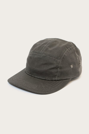 The Bridge & Burn Camper Waxed 5 Panel Cap in Charcoal is a USA-made, dark gray hat featuring five panels, a curved brim, visible stitching, and metal side eyelets, shown on a plain light background.