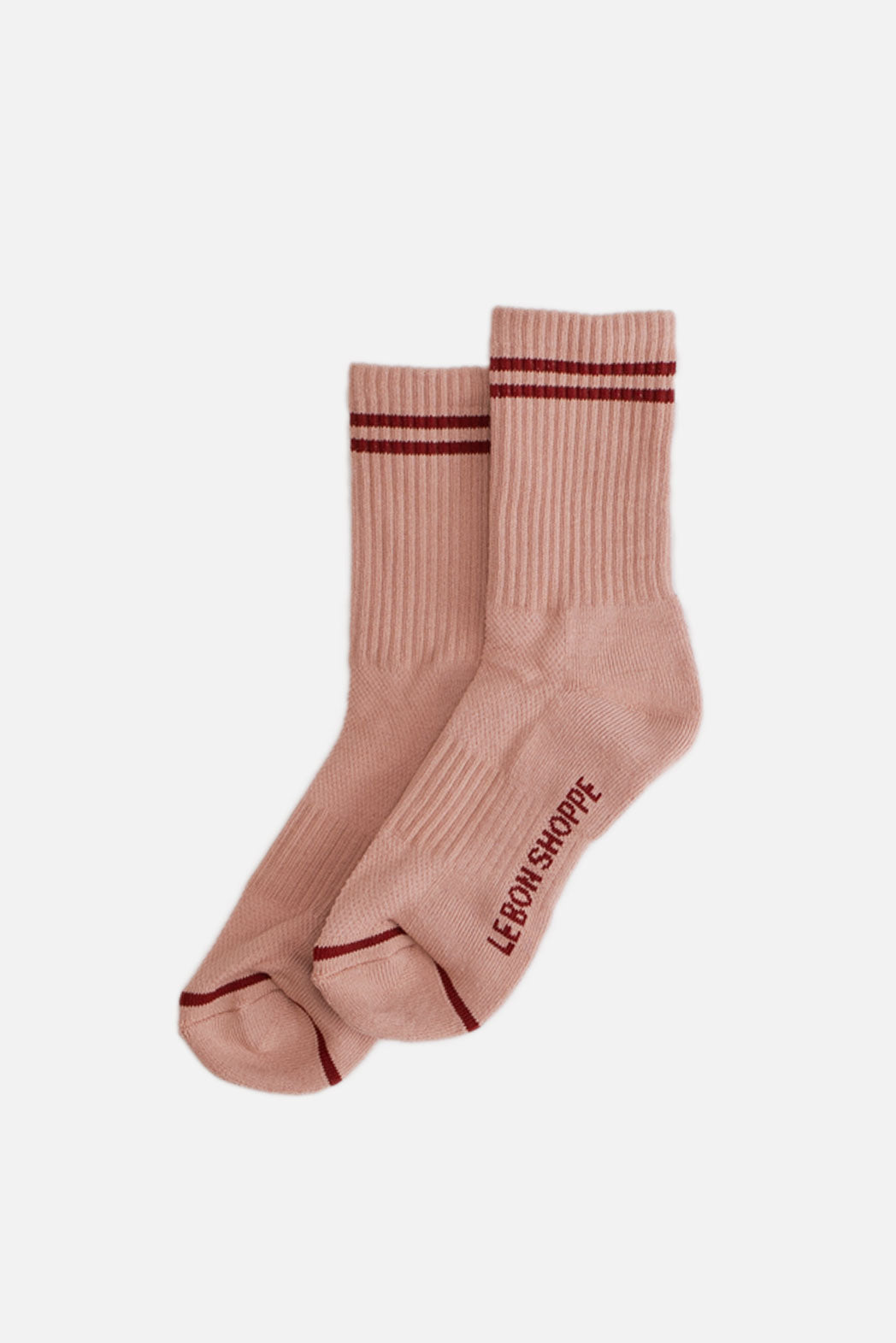 Le Bon Shoppe - Boyfriend Socks in vintage pink, featuring two red stripes near the top and "LEBON SHOPPE" in red on the sole, shown on a plain white background.
