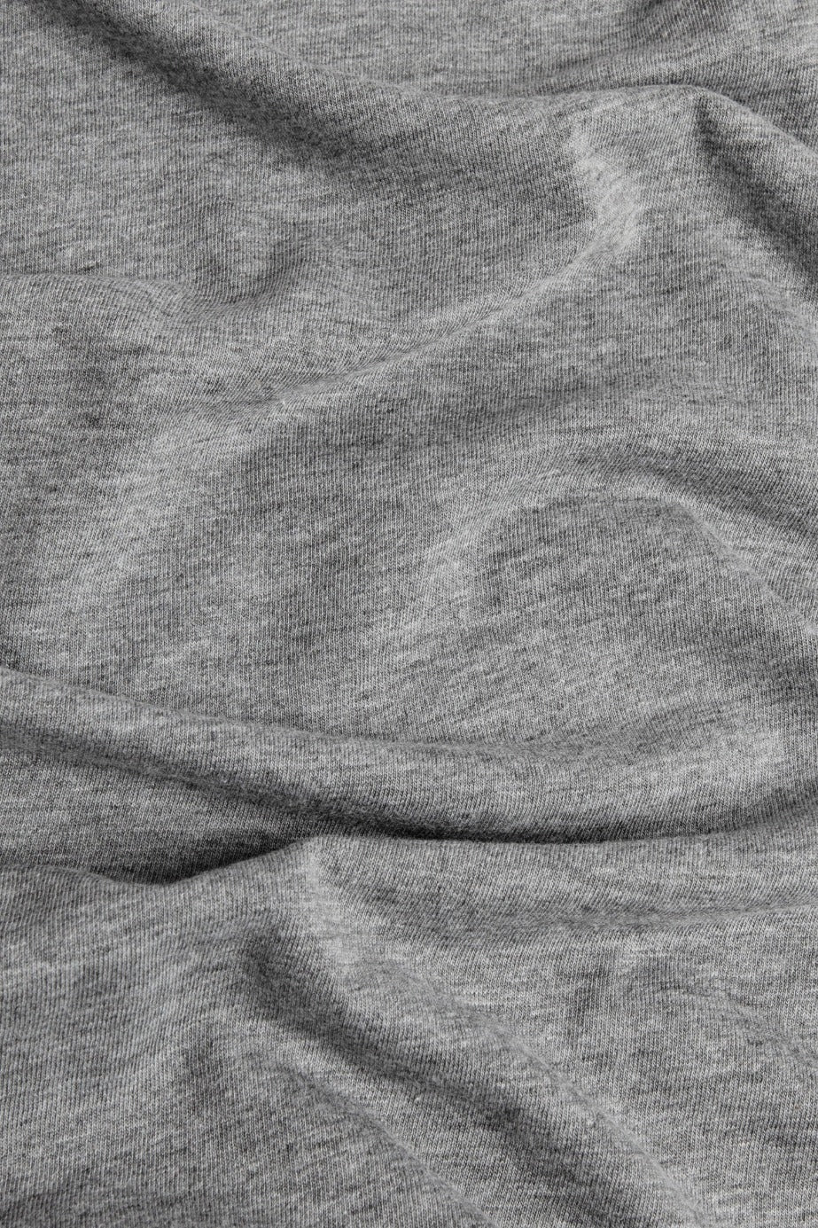 Close-up of the Bridge & Burn Women's Canopy Tee in grey, highlighting the soft texture, natural wrinkles, and fine woven fibers for subtle shading variations.