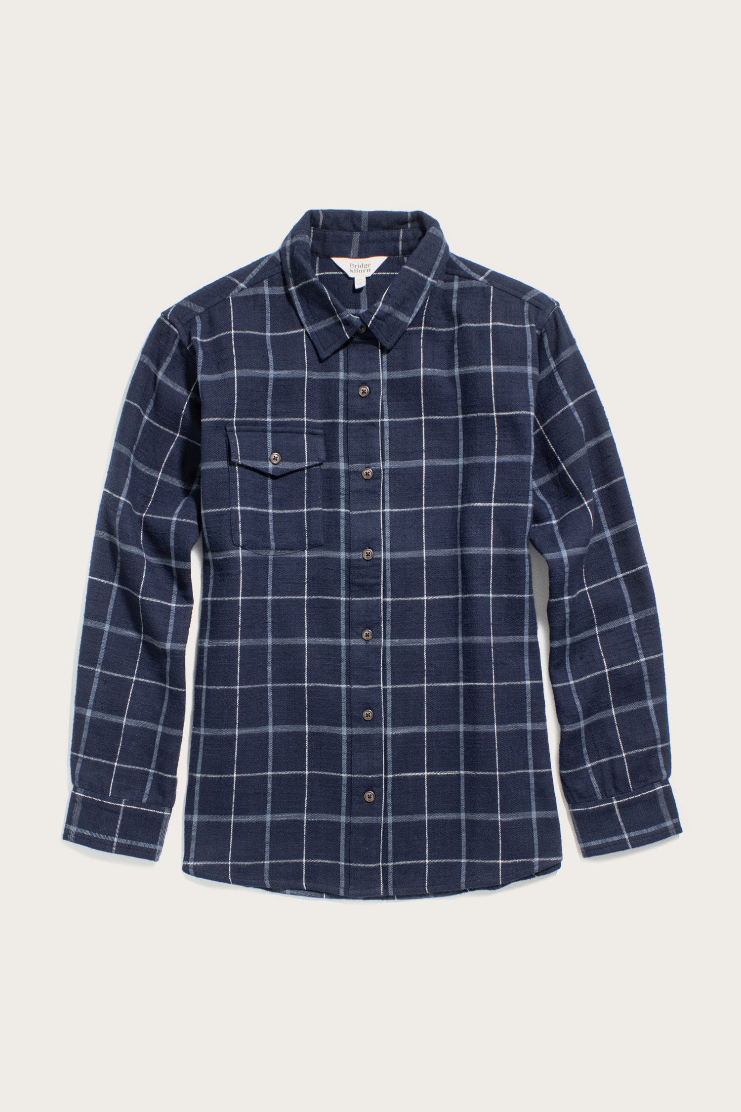 The Bridge & Burn Bird Shirt / Moonrise Windowpane is a navy blue, long-sleeve, button-up flannel with a white windowpane plaid and single chest pocket, made from organic cotton and shown on a plain light background.