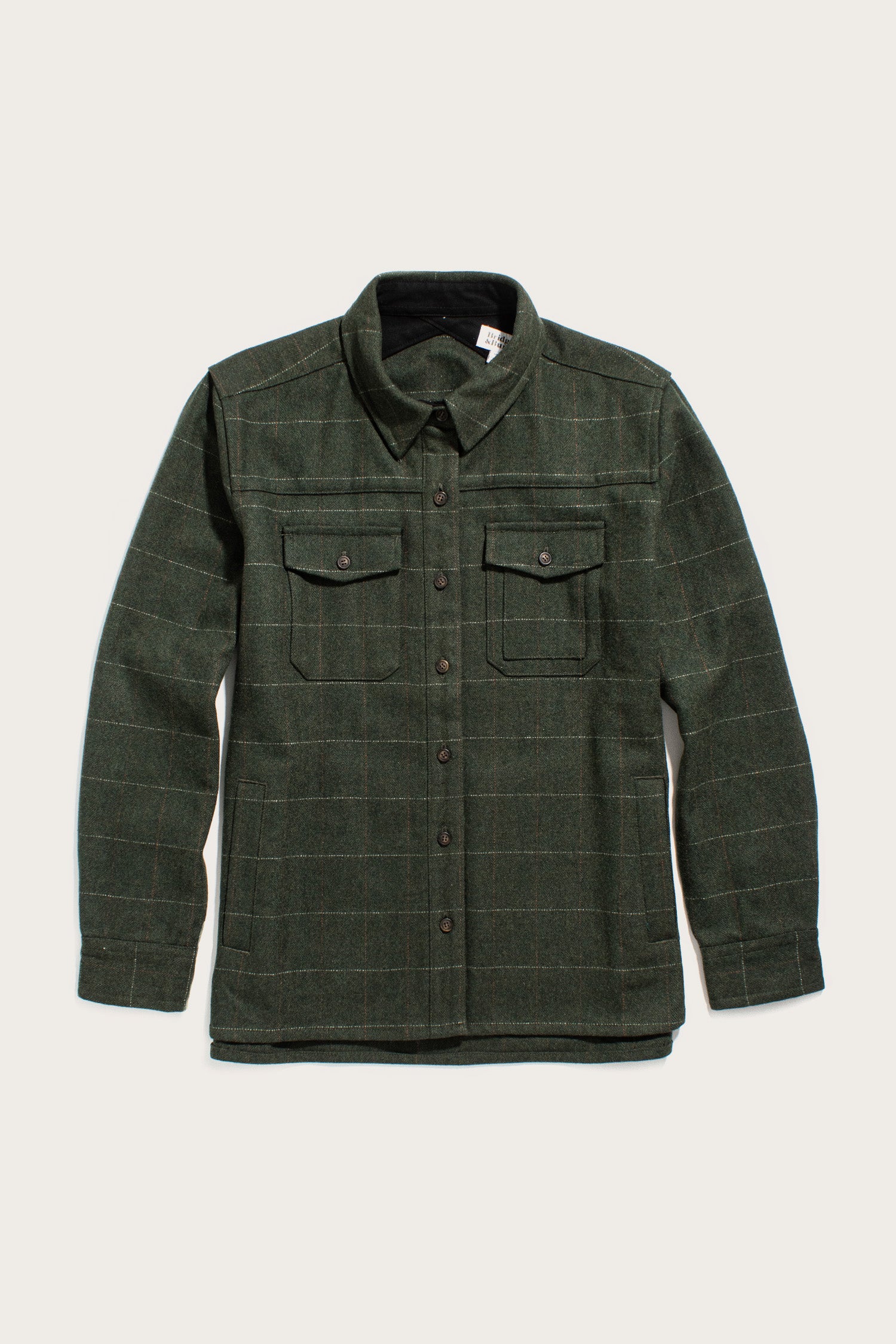 The Bridge & Burn Harlow Shirt Jacket in Cypress Windowpane is a dark green, heavy-weight flannel with long sleeves, button front, two chest pockets, and a collar, shown laid flat on a light background.