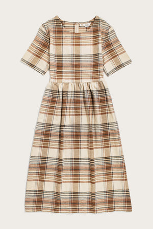 The Perry Dress / Latte Plaid by Bridge & Burn is a midi-length silhouette with short sleeves, a fitted waist, and a brown, beige, and black plaid on cream recycled cotton. A gathered skirt adds fullness for easy charm.