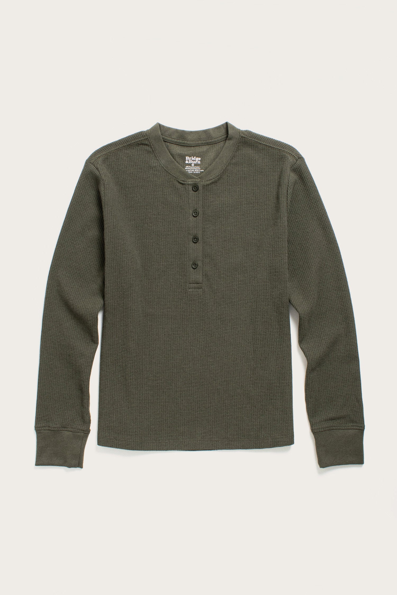 The Bridge & Burn Women's Recycled Waffle Henley in Forest Melange is a long-sleeve, dark green shirt with a round neck and four-button placket, made from recycled fibers and featuring a cozy thermal waffle-knit texture.