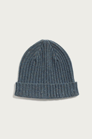 The Bridge & Burn Chunky Ribbed Beanie in Seaside features a speckled blue-gray hue, a folded brim, and a soft, textured finish—crafted for both style and warmth. Shown against a plain white background.