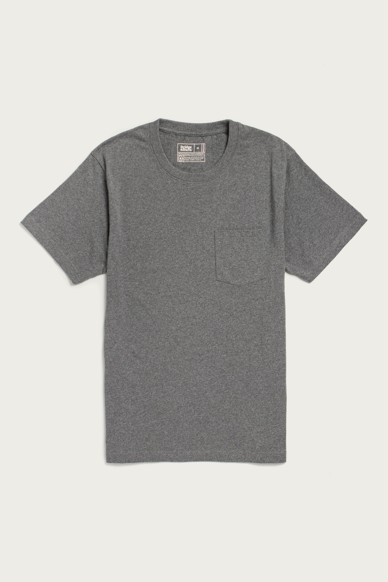 The Bridge & Burn Recycled Pocket Tee in Grey Heather is a short-sleeved, crew neck vintage shirt with a small left chest pocket, shown flat on a white background.