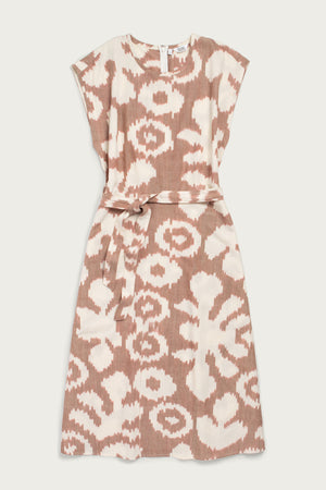 The Eloise Dress in Pop Leaf by Bridge & Burn features a sleeveless A-line cut, round neckline, abstract beige and white print, and a matching fabric belt—an essential piece for any wardrobe.