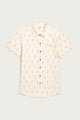 The Bridge & Burn Lana Shirt in Dune Chevron is a relaxed-fit, short sleeve button-up in light beige with a chest pocket and an all-over subtle red and brown chevron pattern.