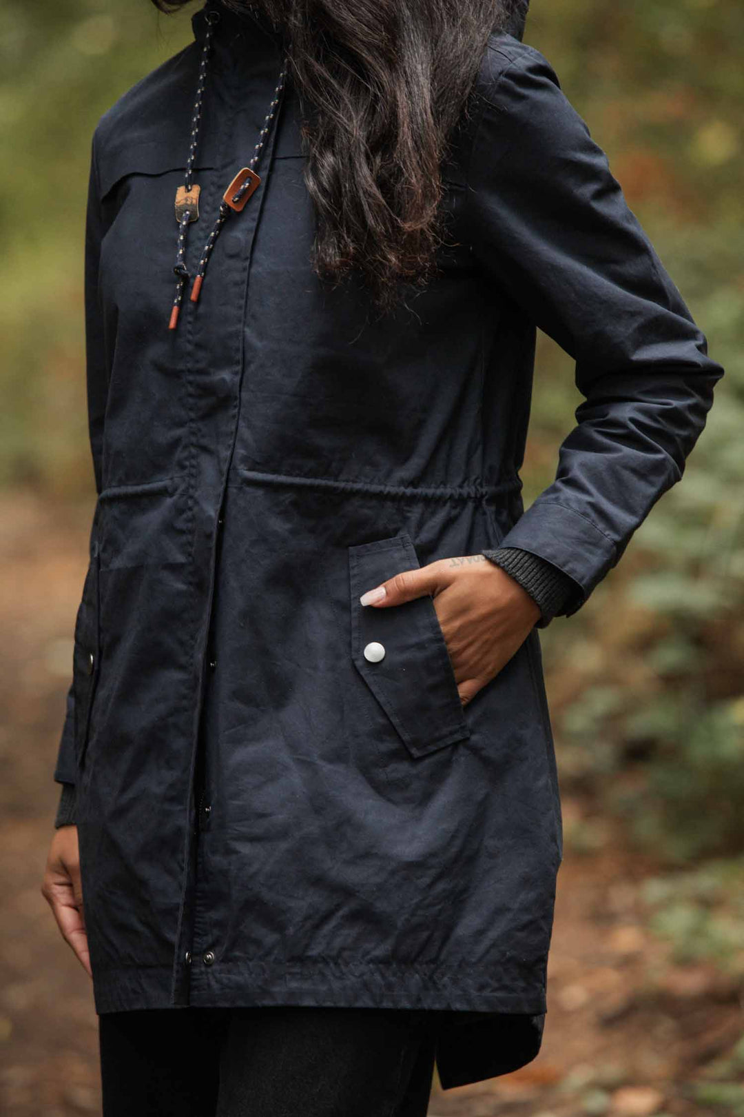 A woman wearing the Bridge & Burn Briar Jacket in navy waxed canvas.