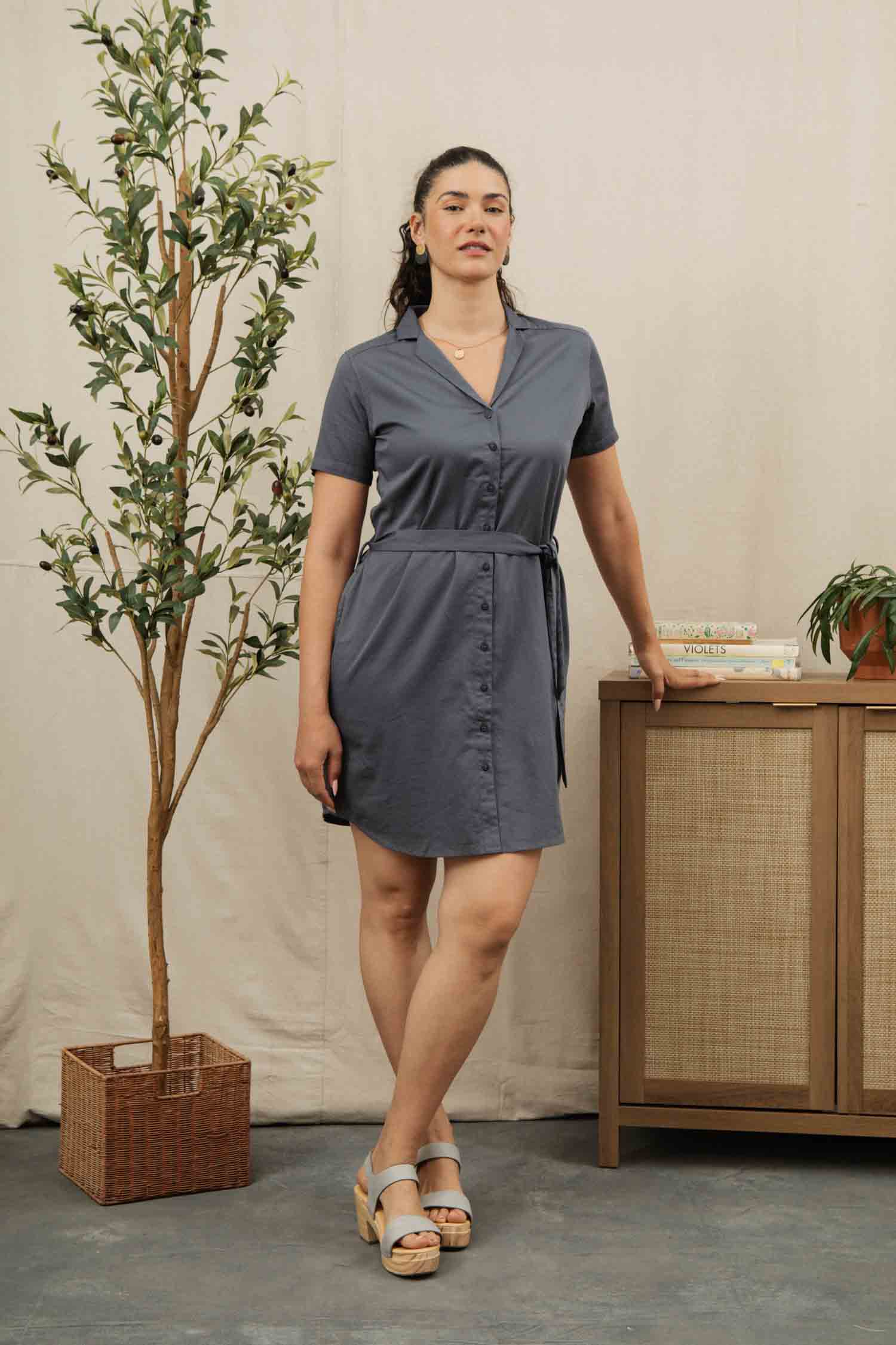 The Bridge & Burn Sofia Shirt Dress in light navy features short sleeves, a button front, a collar, and a matching fabric belt, shown laid flat on a light background.