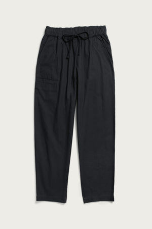 The Bridge & Burn Lark Pant in Soft Black features a relaxed fit, organic cotton fabric, elastic waistband with drawstring, side pockets, and a right patch pocket. Pants are shown laid flat on a light background.