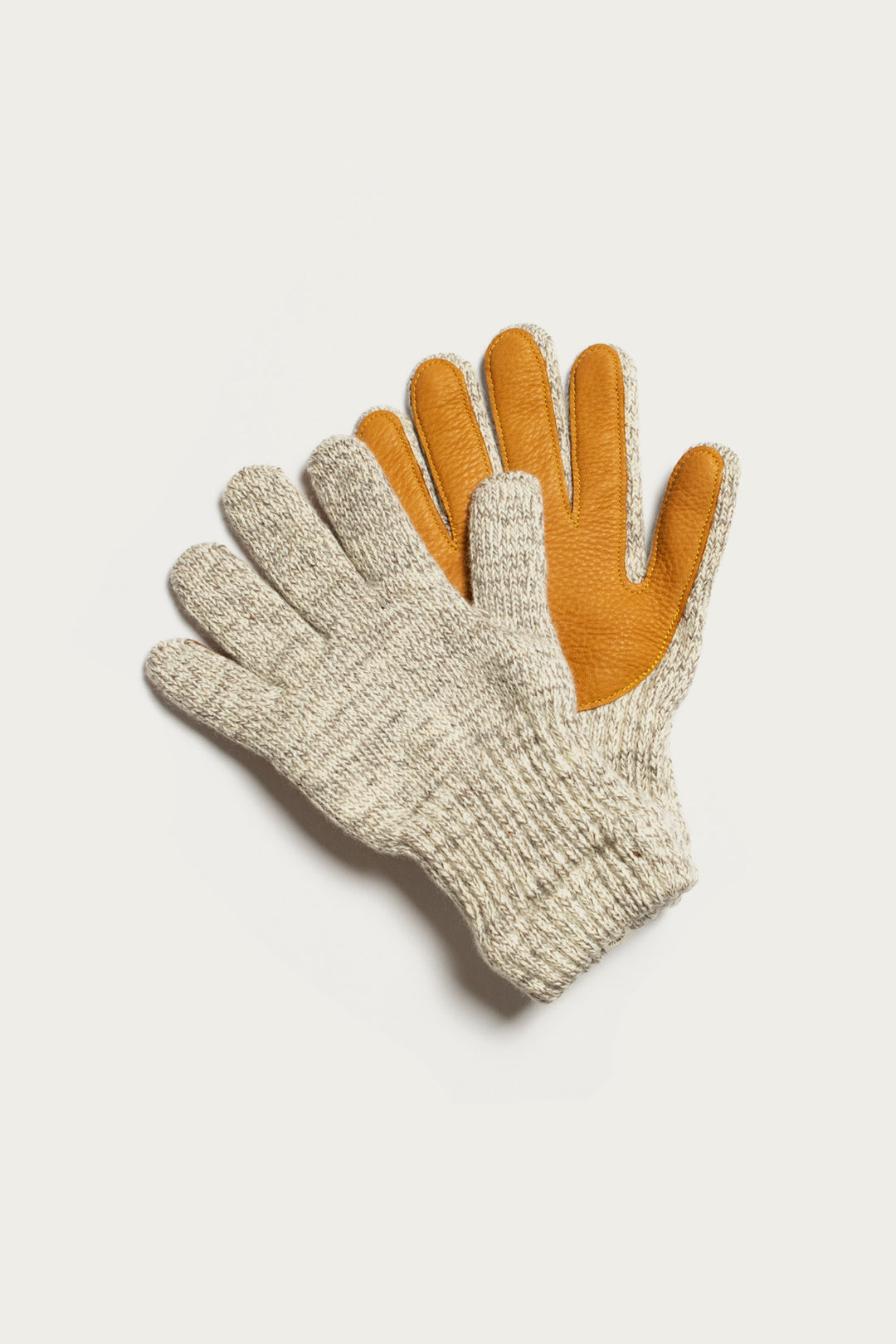 The Bridge & Burn Ragg Wool Lined Glove in Oatmeal features gray wool knit exteriors and yellow-brown leather palms, shown on a white background.