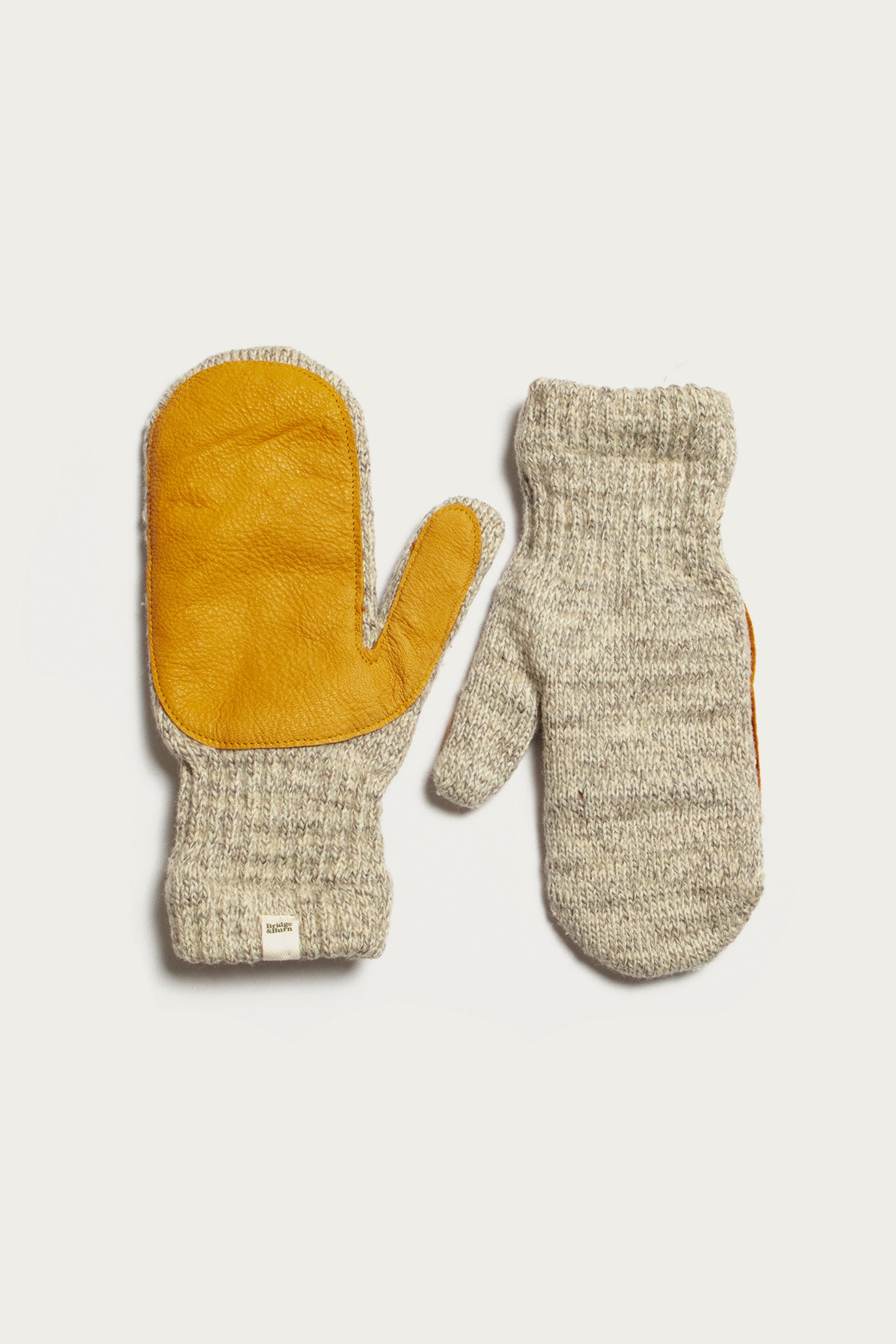 The Bridge & Burn Ragg Wool Lined Mitten in Oatmeal features yellow leather palms and gray wool on the reverse, made in the USA and shown on a white background.