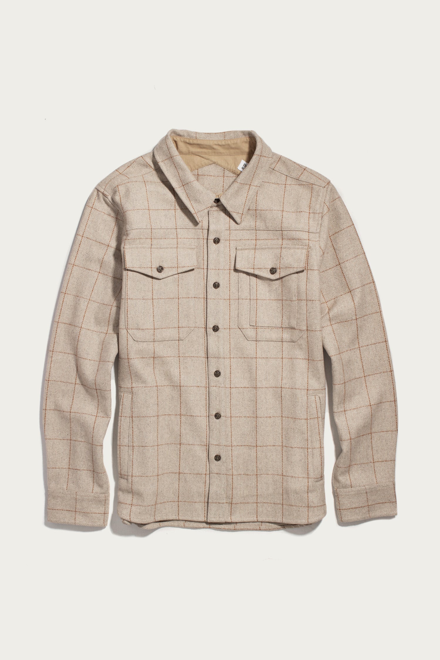 The Bridge & Burn Fielding Shirt Jacket in Stonecross features a beige plaid pattern, long sleeves, button-up front, and two chest pockets. It is shown laid flat on a white background.