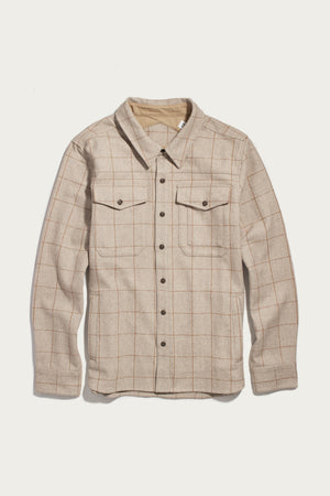 The Bridge & Burn Fielding Shirt Jacket in Stonecross features a beige plaid pattern, long sleeves, button-up front, and two chest pockets. It is shown laid flat on a white background.