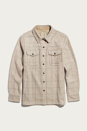 The Bridge & Burn Harlow Shirt Jacket in Stonecross is a beige long-sleeve wool shirt jacket with a light brown windowpane plaid, workwear-style elbow patches, chest pockets with button flaps, and a pointed collar, shown flat on a white background.