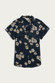 The Bridge & Burn Innes Shirt in Night Garden is a relaxed-fit, short sleeve, button-up shirt with a dark navy base and white-yellow floral pattern, crafted from organic cotton. Displayed flat on a white surface.