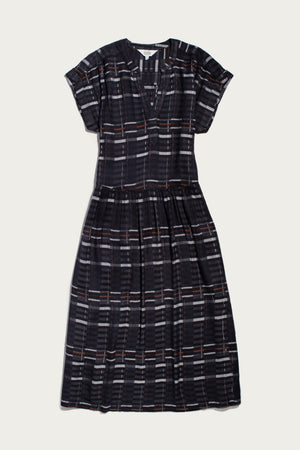The Ira Dress by Bridge & Burn features short sleeves, a knee-length pullover design in Nightfall Stripe, with a V-neck, subtle waist pleats, and a relaxed fit.
