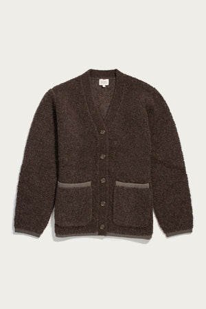 The Bridge & Burn Whit Cardigan in dark olive is a textured wool-blend sweater with long sleeves, V-neck, button front, two pockets, and light brown trim. Machine wash or dry clean. Shown laid flat on a white background.