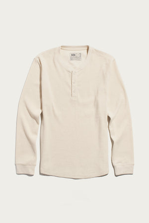 The Bridge & Burn Men’s Recycled Waffle Henley in Ivory—a long-sleeve, cream-colored shirt featuring a classic waffle-knit texture and three-button placket—is designed for effortless thermal layering and is shown laid flat on a white background.